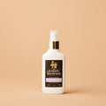 White bottle with a black label on a beige background