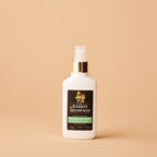 White spray bottle with a black label on a beige background