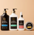 Four Barkin Meowson pet grooming products arranged on a warm beige background: a black pump bottle, a white pump bottle, a white spray bottle, and a round tin with the brand name visible on the labels.