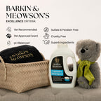 Barkin & Meowson's laundry detergent bottle with a teddy bear and basket on a couch.