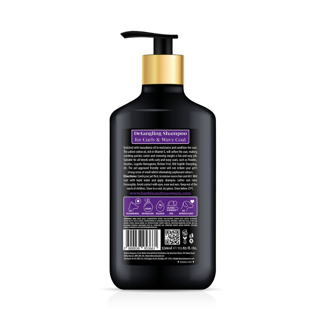 Black shampoo bottle with gold pump on a white background