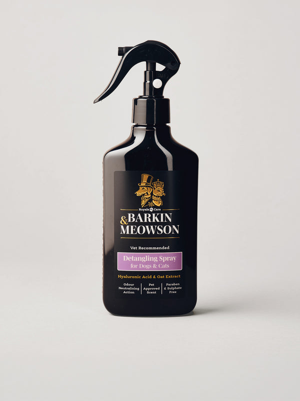 A black spray bottle of Barkin Meowson Detangling Spray for Dogs & Cats, featuring a black trigger sprayer and a label with gold and purple text, set against a light gray background.
