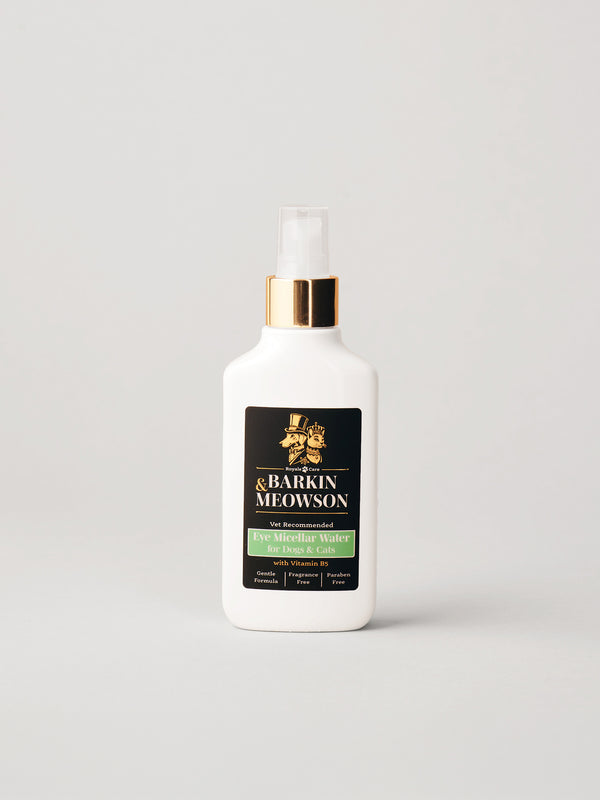 A white bottle of Barkin & Meowson eye micellar water with a gold collar and clear spray top, set against a neutral light gray background.