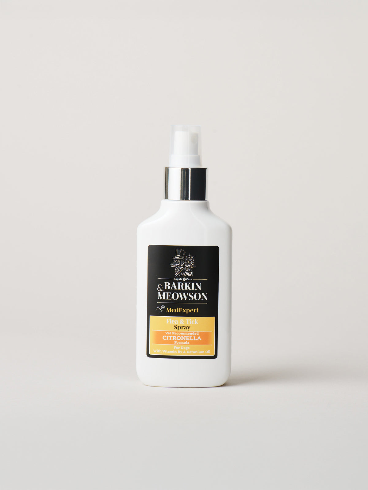 A white bottle of &Barkin Meowson Flea&Tick with a black and gold label, standing on a light gray background.