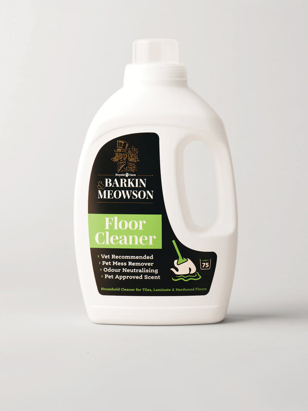 A white plastic bottle of Barkin Meowson Floor Cleaner with a black and green label, photographed on a light gray background.