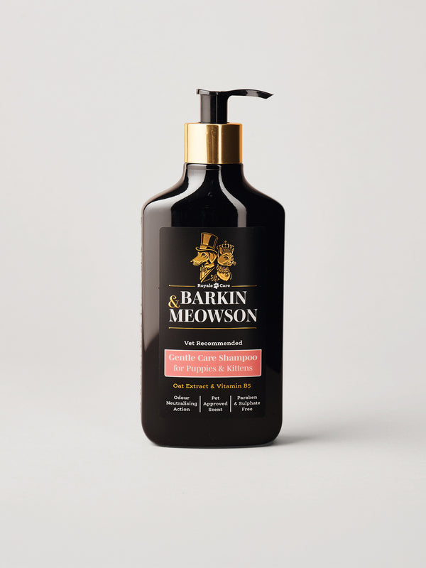A bottle of Barkin Meowson Gentle Care Shampoo on a light gray background. The bottle is black with a gold pump collar and a black label featuring gold text and a pinkish-red recommendation banner.