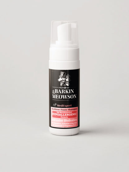 A white pump bottle of Barkin MeowsonDry Shampoo with a black and red label, set against a plain light gray background.