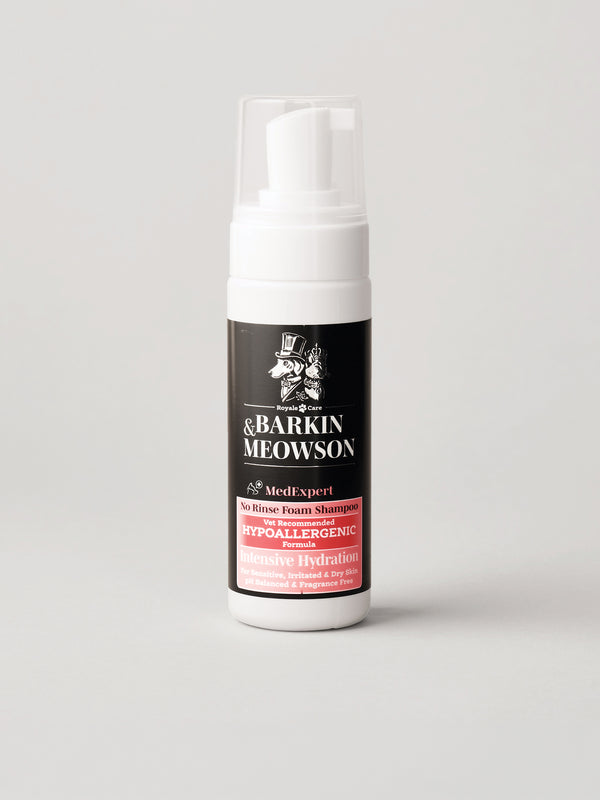 A white pump bottle of Barkin MeowsonDry Shampoo with a black and red label, set against a plain light gray background.