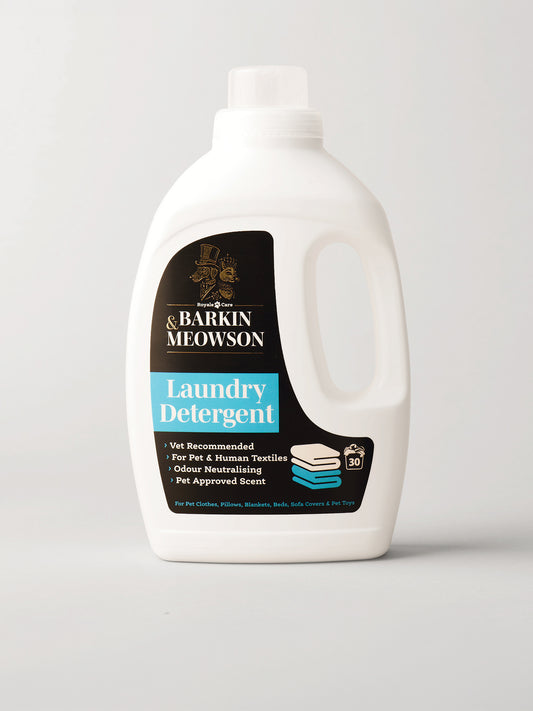 A white plastic bottle of Barkin Meowson Laundry Detergent with a black and blue label, photographed on a light gray background.