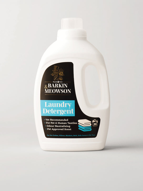 A white plastic bottle of Barkin Meowson Laundry Detergent with a black and blue label, photographed on a light gray background.