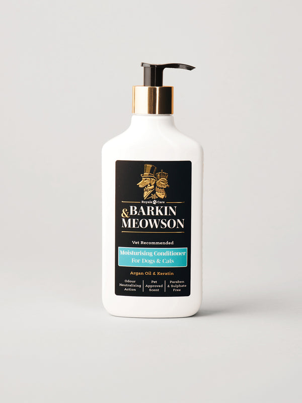 A white bottle of Barkin Meowson Grooming Conditioner with a black pump, gold collar, and black label with gold and teal text, set against a light gray background.