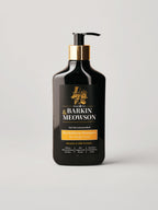 A bottle of Barkin Meowson haircare product with a black body, gold collar, and black pump, shown on a light gray background.