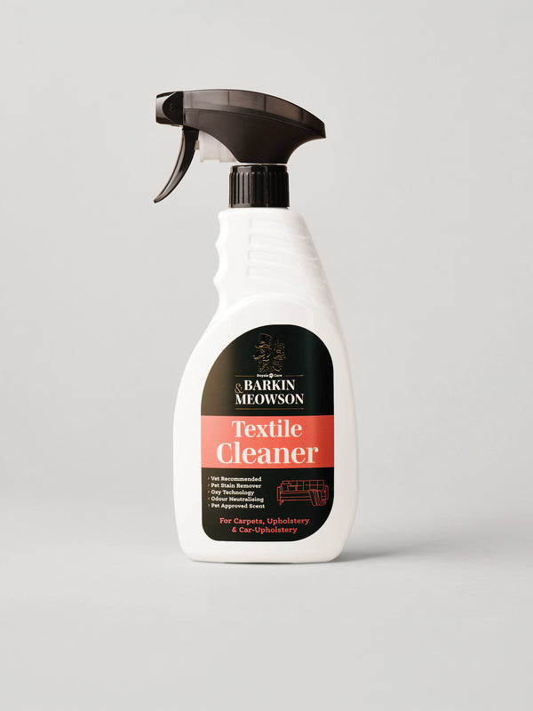 A white spray bottle of Barkin Meowson Textile Cleaner with a black trigger sprayer and a black and red label, set against a solid light gray background.