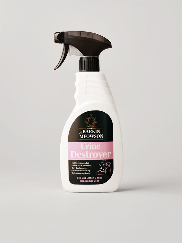 A white spray bottle of Barkin & Meowson Urine Destroyer, featuring a black trigger sprayer and a label with black and pink sections, set against a plain light gray background.