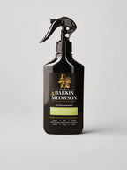 A black trigger spray bottle of Barkin Meowson Volume Boost Spray for Cats & Dogs, featuring a black label with gold and green text, set against a light gray background.