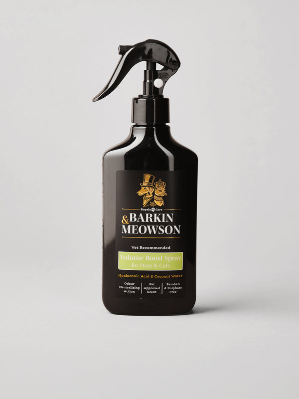 A black trigger spray bottle of Barkin Meowson Volume Boost Spray for Cats & Dogs, featuring a black label with gold and green text, set against a light gray background.